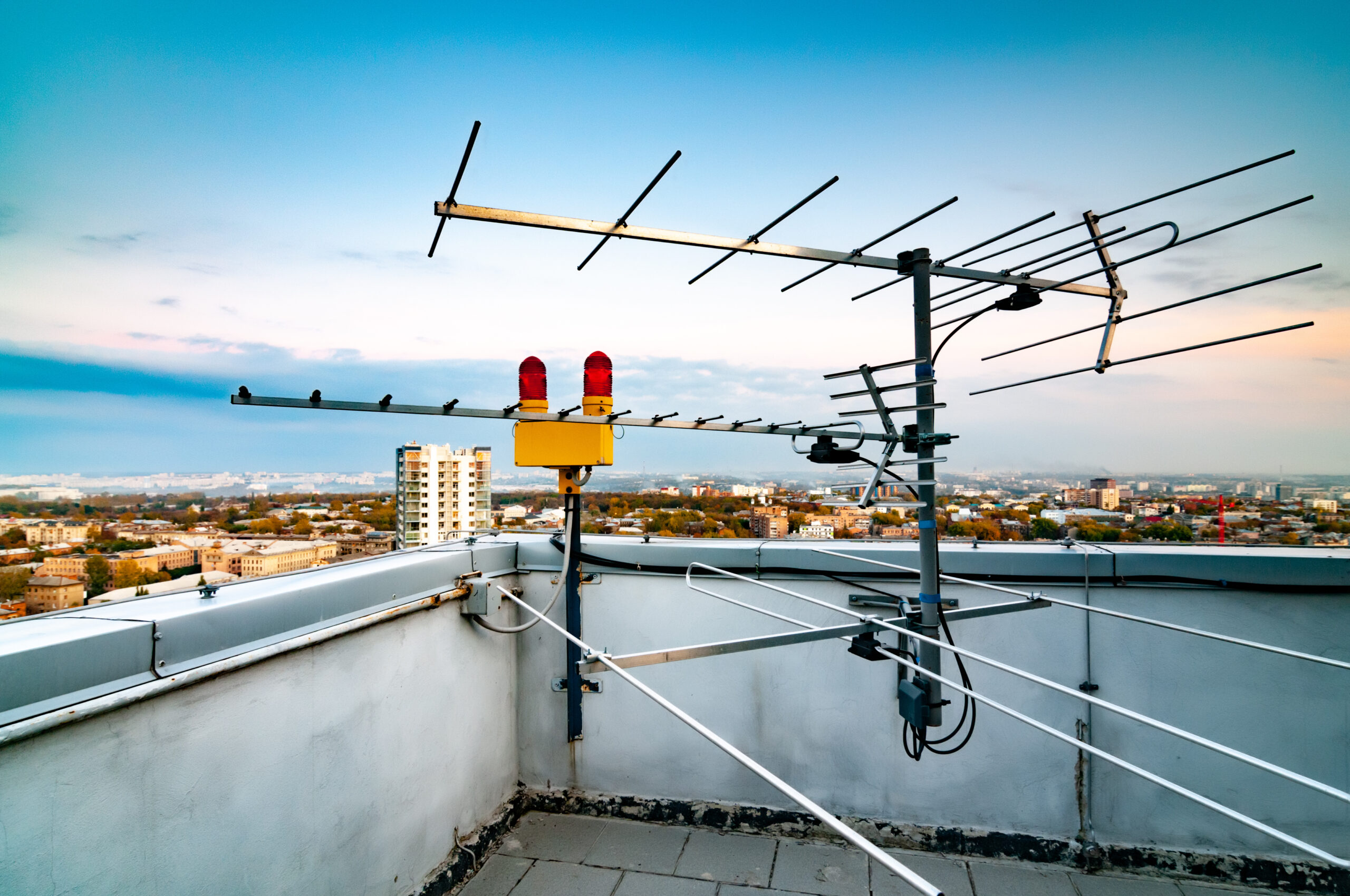 New hight buildings in the city with roofs full of old television antennas and lightning protection